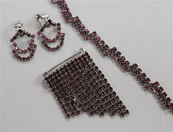 A demi parure of paste set jewellery including a pair of earrings, brooch and bracelet.